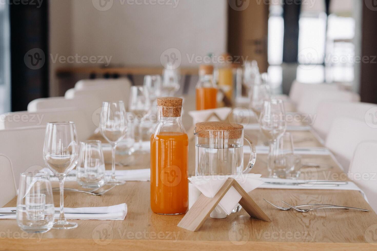 Empty dishes and cutlery on the table in the restaurant before dinner photo