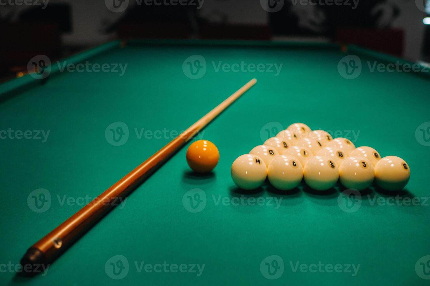 Playing pool on a green table.Balls and cue are laid out on the table photo