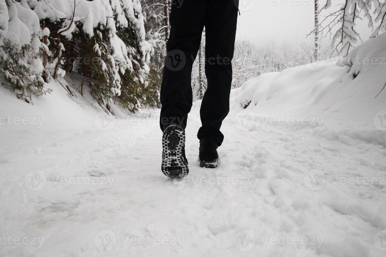 Shot of boots muddy from snow in Beskydy mountains in the eastern part of the Czech Republic. White fairy tale in winter months photo