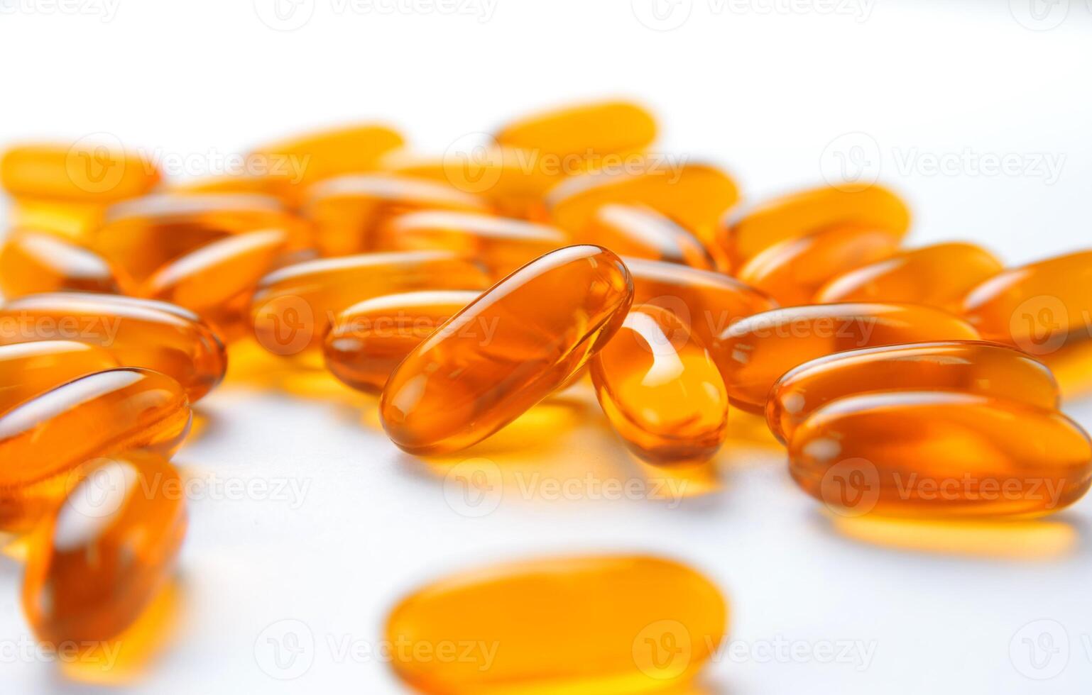 close up to pile of Fish oil capsules on a white background. soft gels capsules photo
