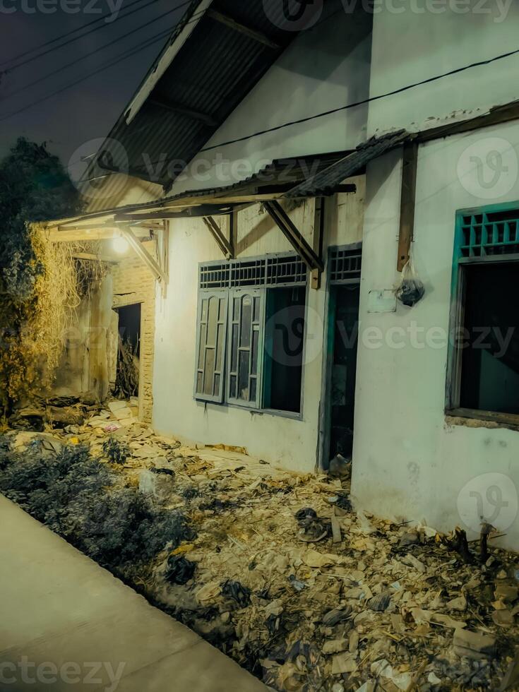 a house with a broken window and a broken door photo