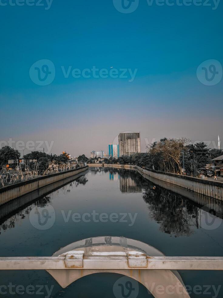 a view of a canal in front of a city photo