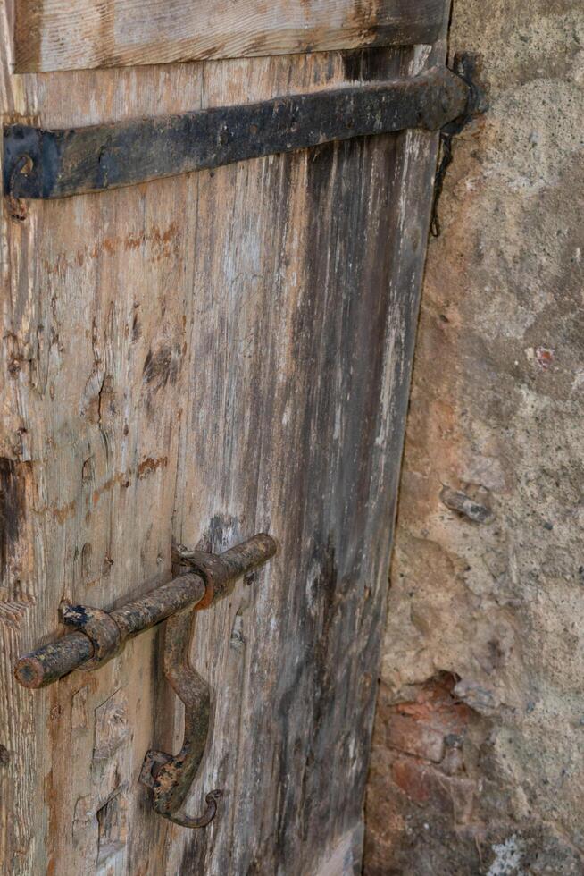 Old castle doors with ancient metal latch in the castle. photo