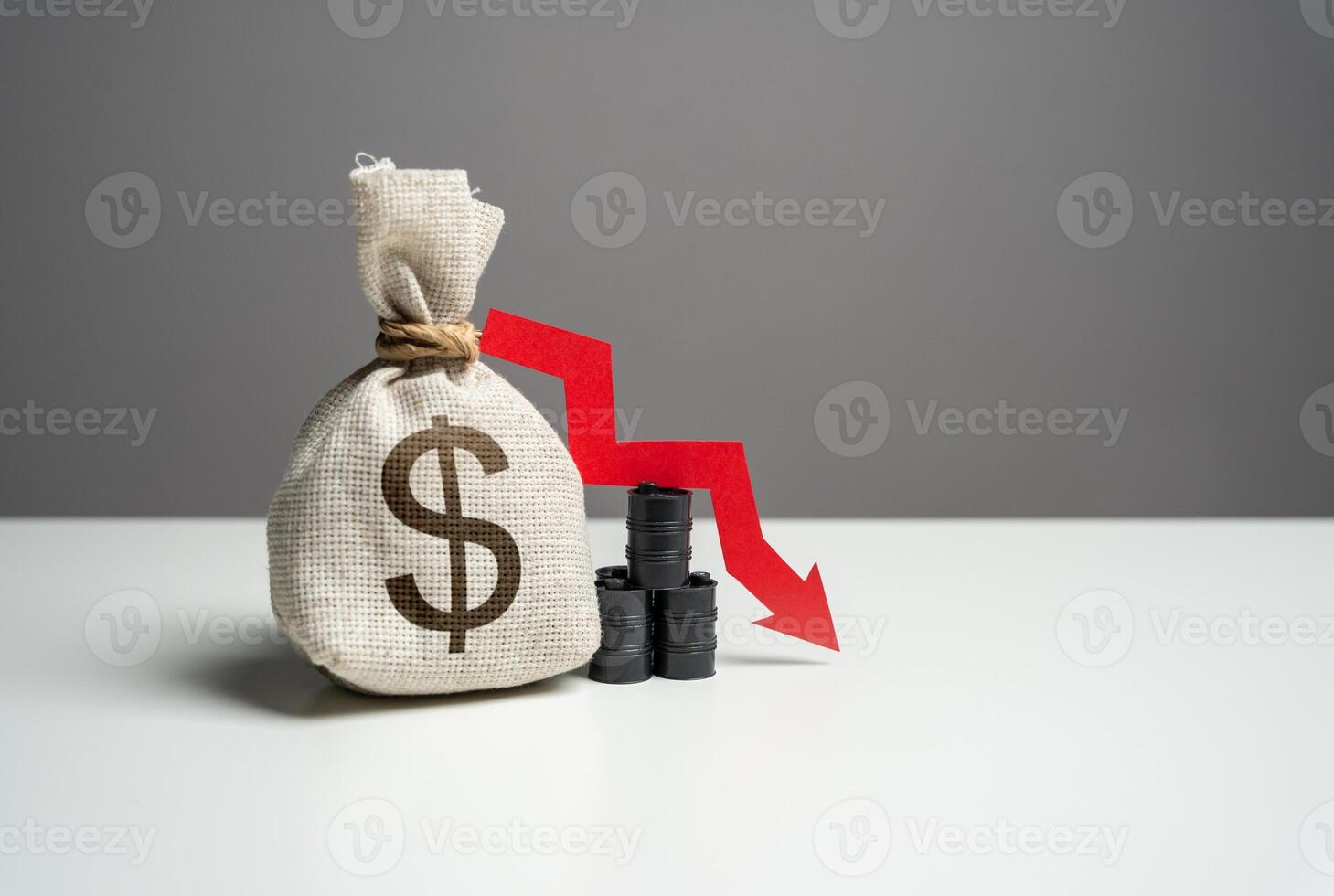 Oil barrels and dollar money bag and red arrow down. Trade and fall of oil transportation. Falling profit from the sale of energy resources and petroleum products. Negative prognosis photo