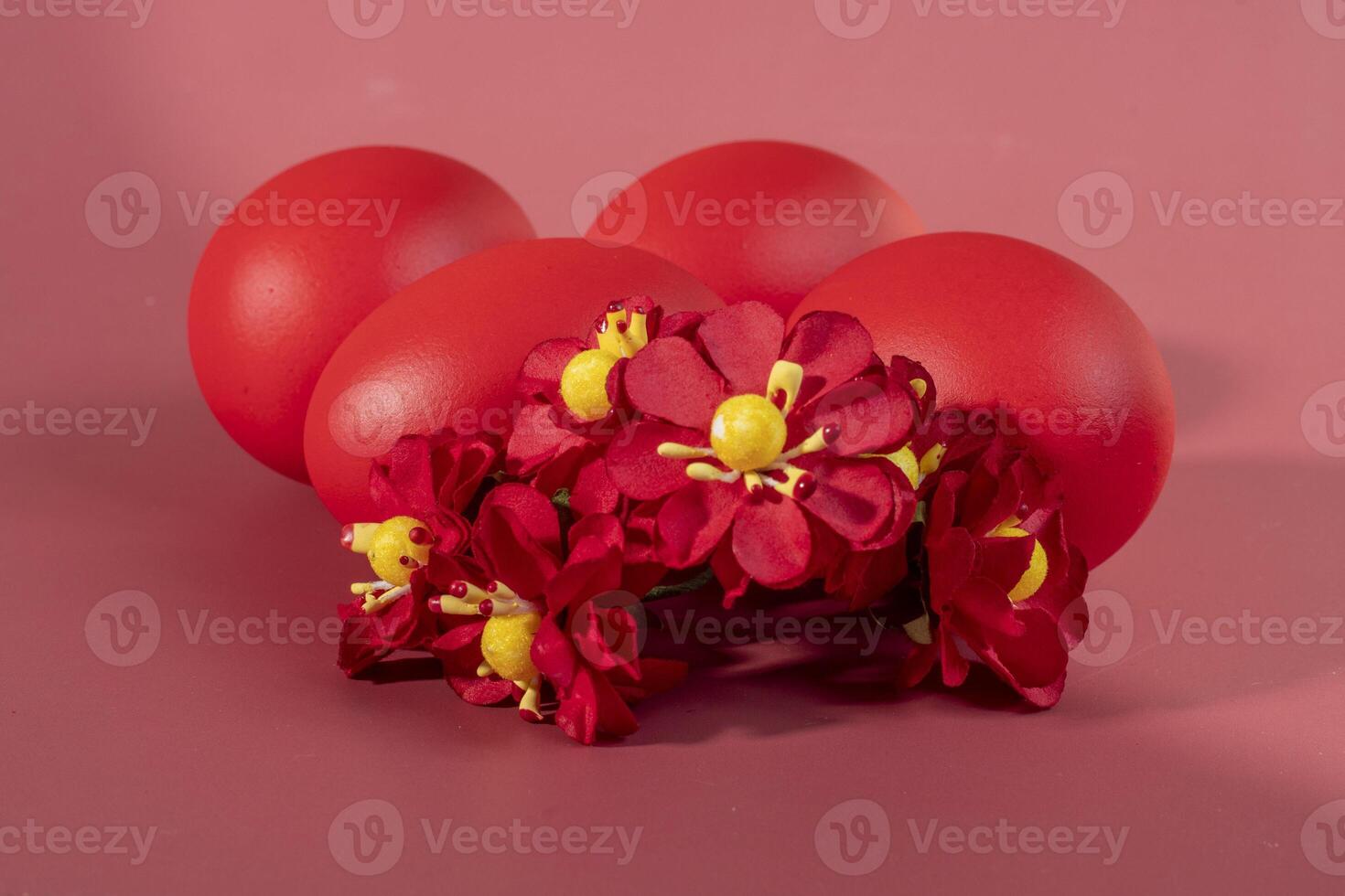 Colorful eggs, symbolizing Easter, on a colorful background and flowers photo