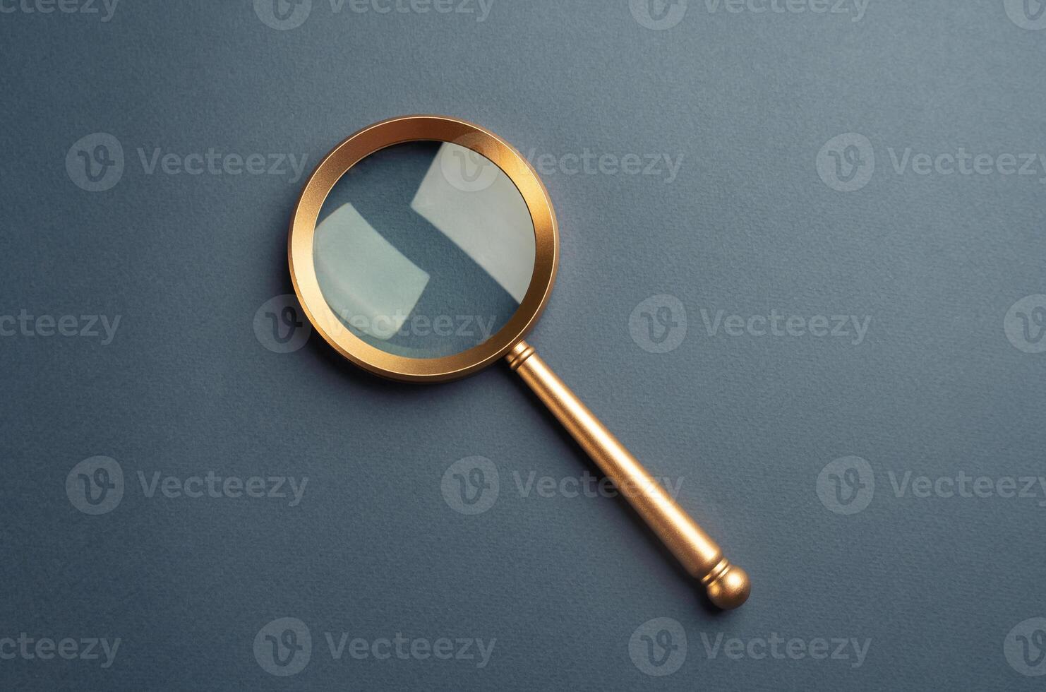 Magnifying glass on a gray background. Vintage. FAQ. Curiosity, inquiry, uncertainty. Search for answers, clarity, and understanding. Quest for knowledge or solutions. Solving mysteries photo