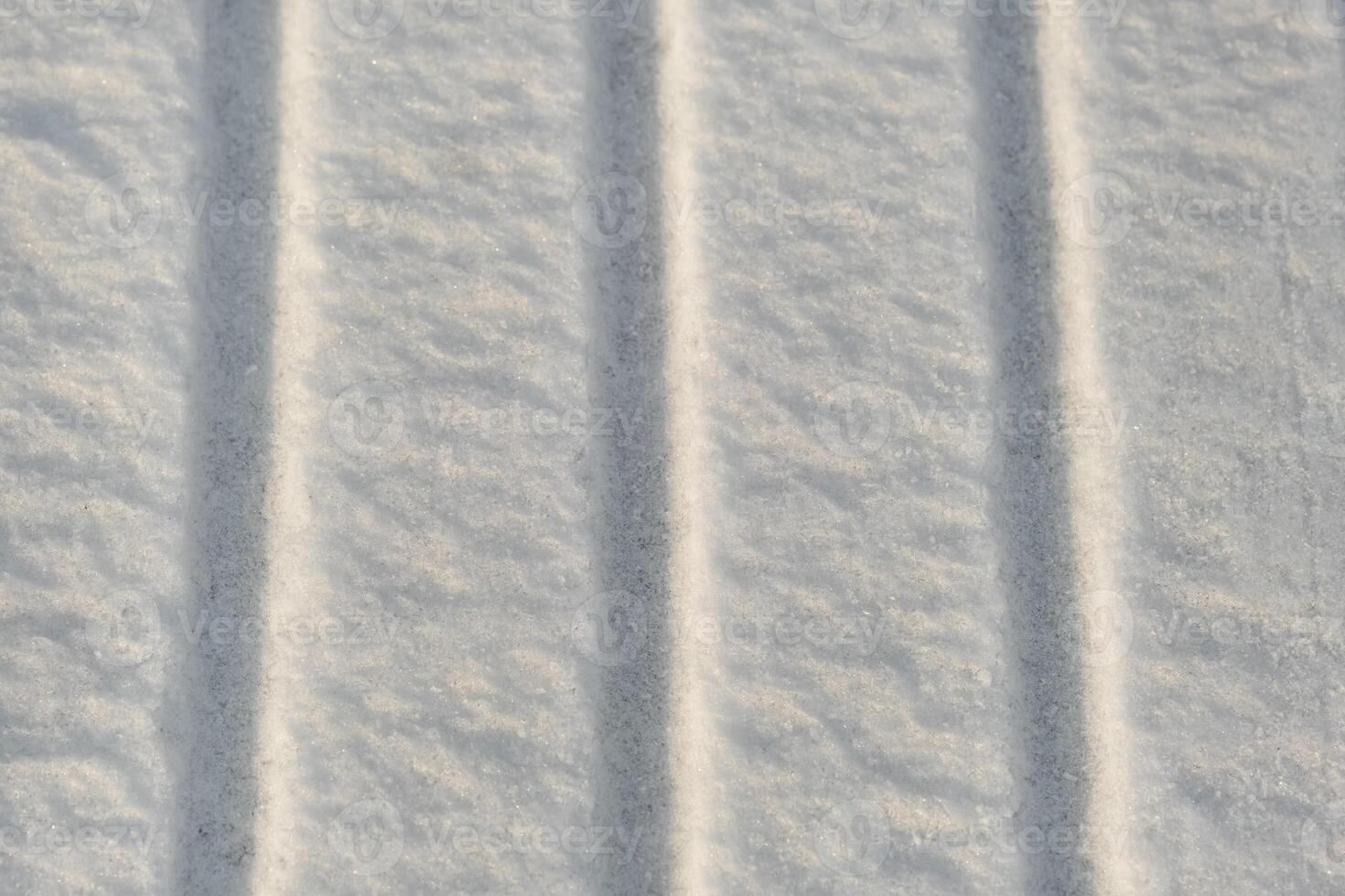 winter background. The texture of snow with stripes. Pure white snow photo