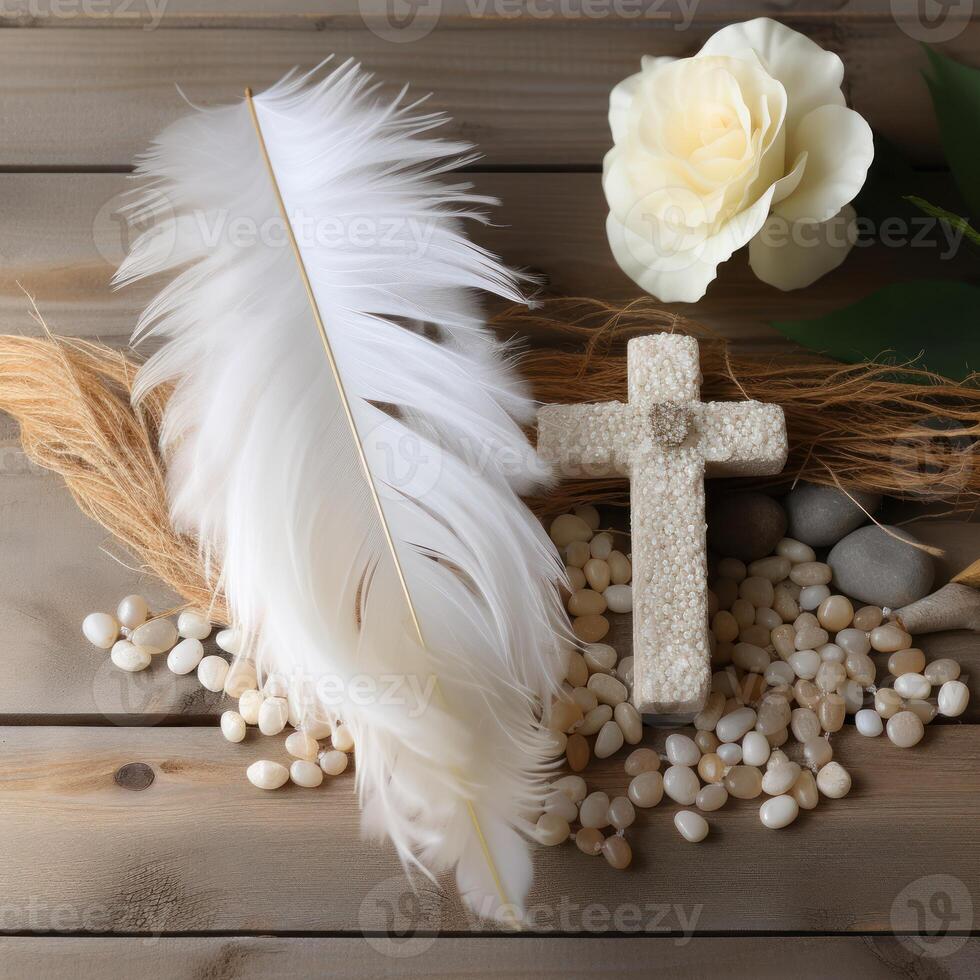 AI generated White stone cross with feather and pebbles on wood background, palm sunday greetings photo