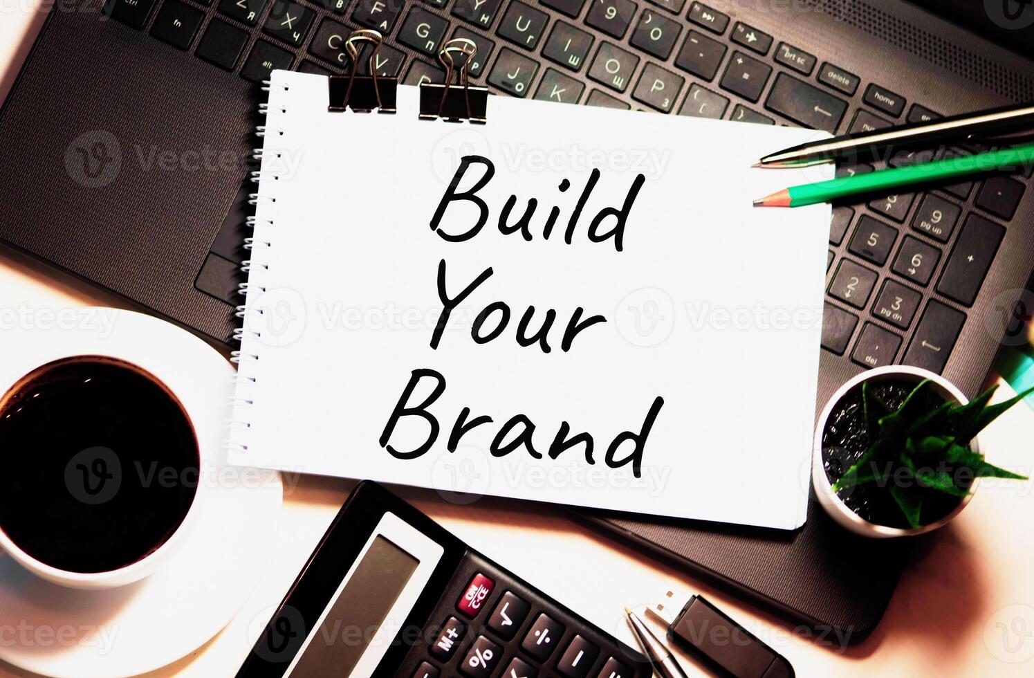 BULD YOUR BRAND written on white piece of paper photo