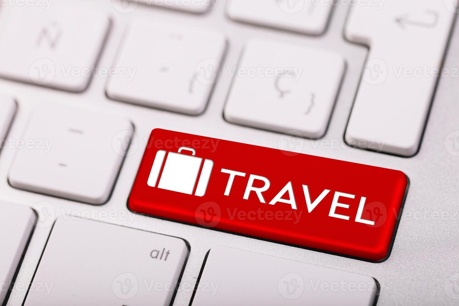 Computer keyboard with red button and word Travel. Tourist agency photo