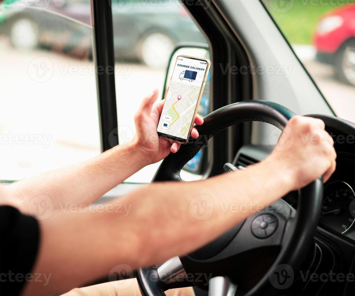 The man in the car is holding the Maps application photo