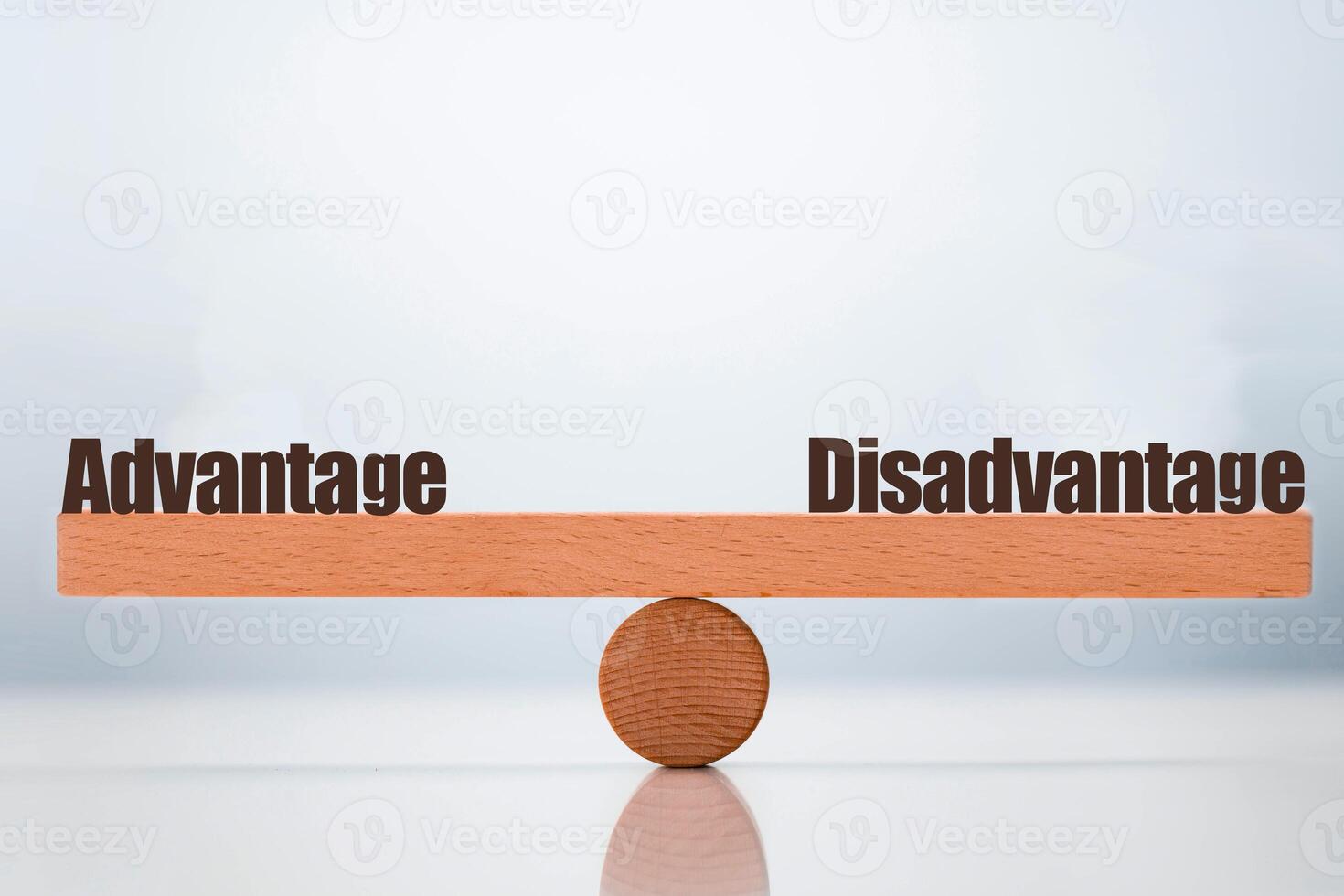 advantage vs disadvantage word balancing on seesaw choice concept photo