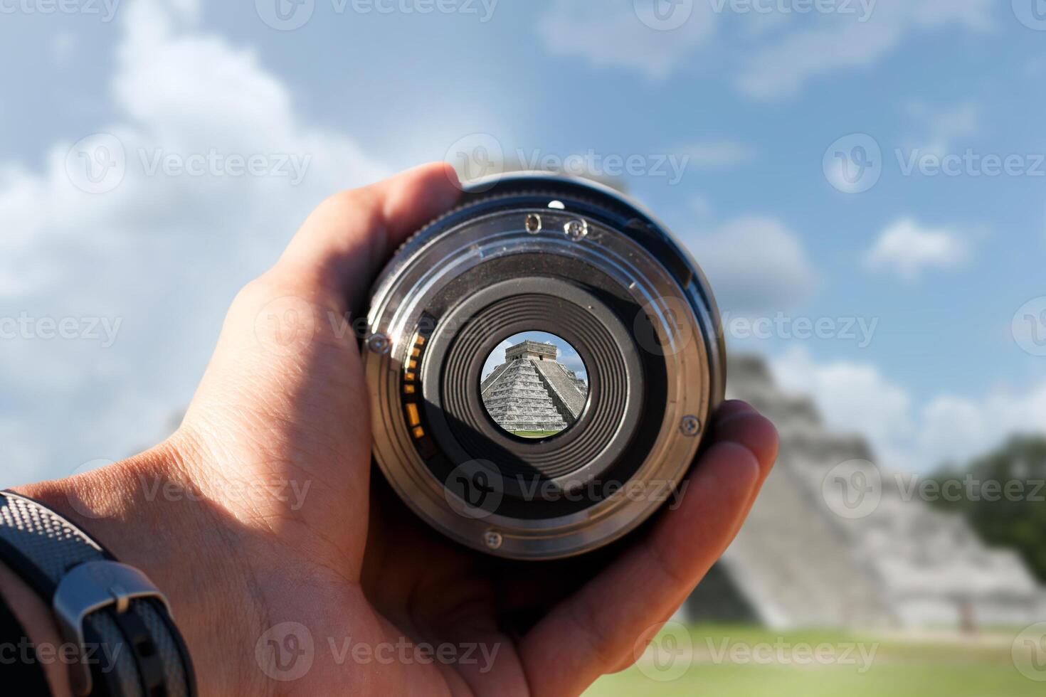 selective focus shot person holding camera lens on Chichen Itza tourist taking a picture with camera lens on Chichen Itza photo