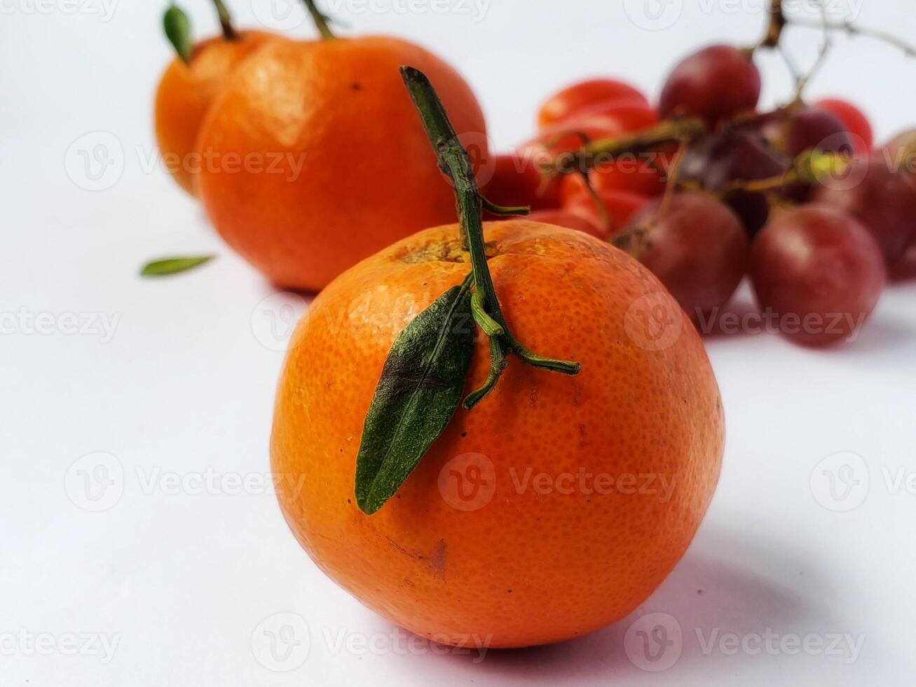 Orange and green leaves isolated on white background. photo