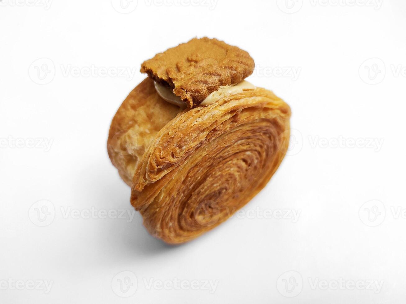 Cromboloni, New York Roll Croissant with biscoff topping, isolated white background. photo