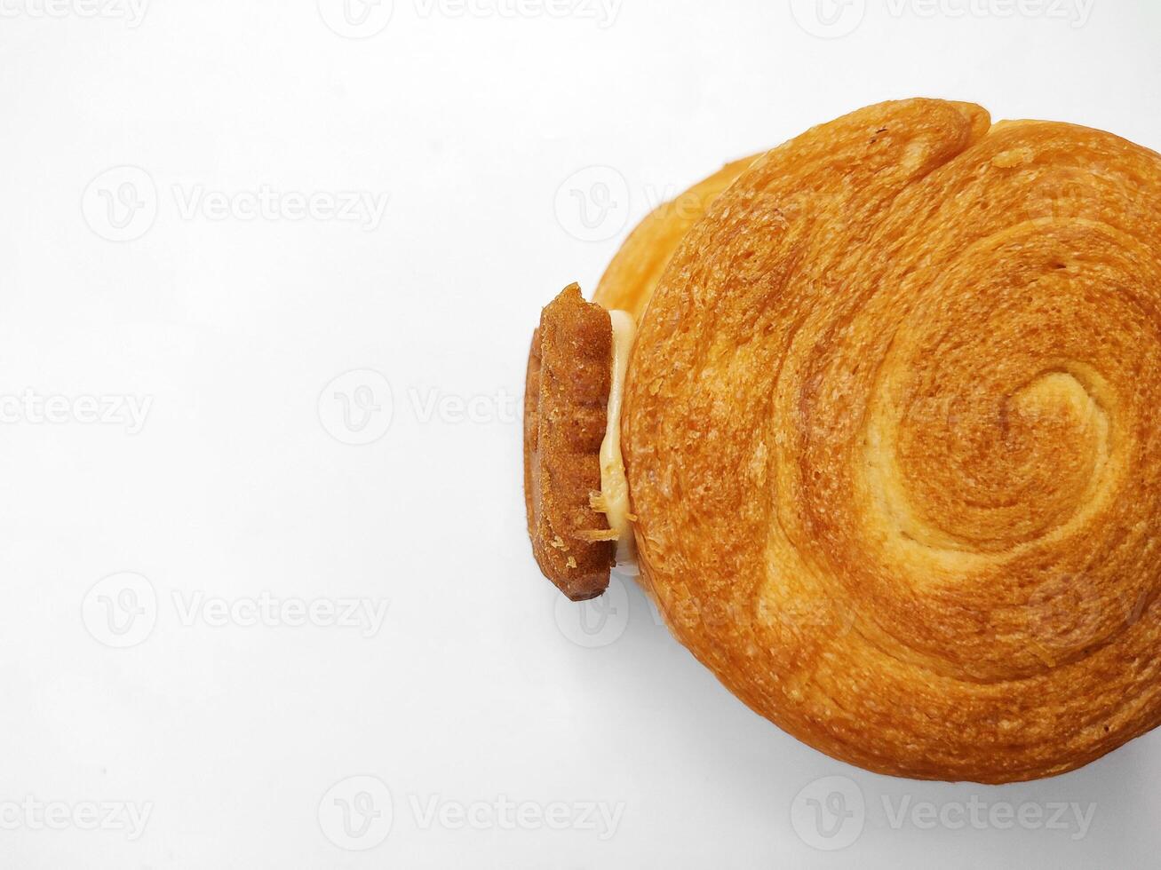 Cromboloni, New York Roll Croissant with biscoff topping, isolated white background. photo