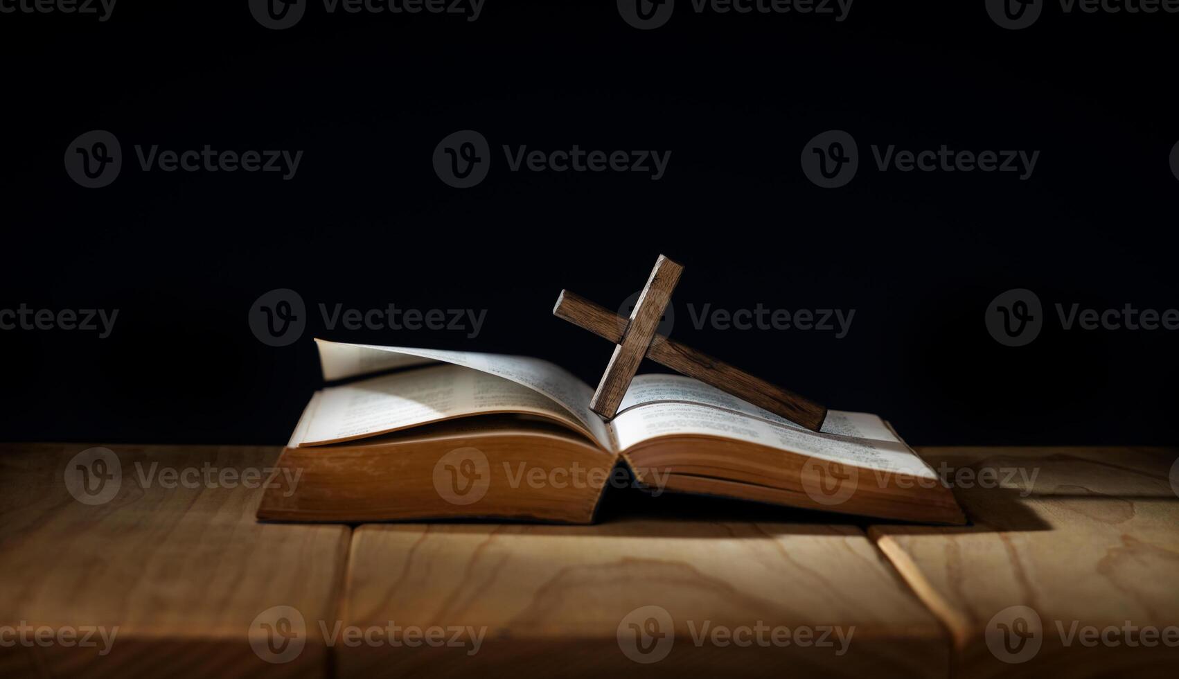 Spirituality, Religion and Hope Concept. Praying in the Dark Place. Supplication, Believe and Faith for Human. Hope in the midst of the Broken. Aged Bible and Cross on  Wooden  Table photo