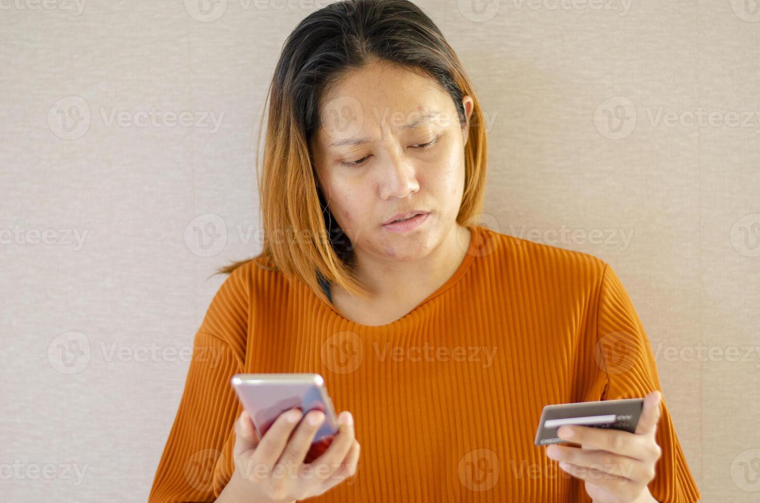 Stressed woman, scammer stealing money from online transaction, holding credit card and mobile phone, Isolate background photo