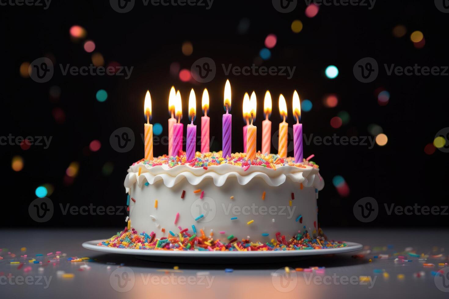 Colorful birthday cake with 21 candles and sprinkles photo