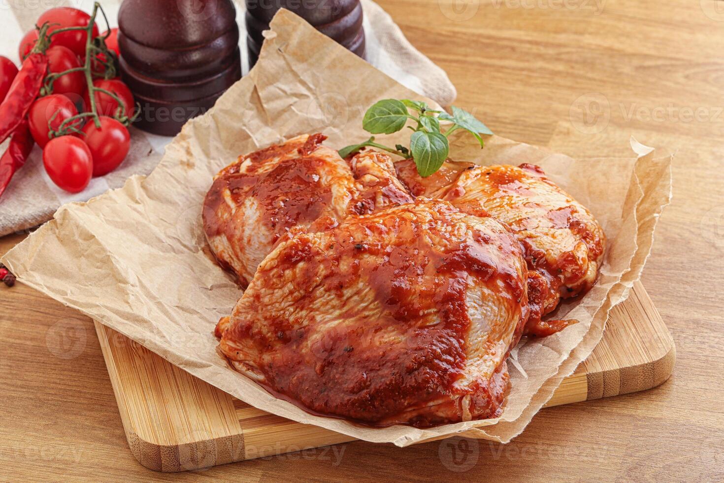 Marinated chicken leg in tomato sauce photo