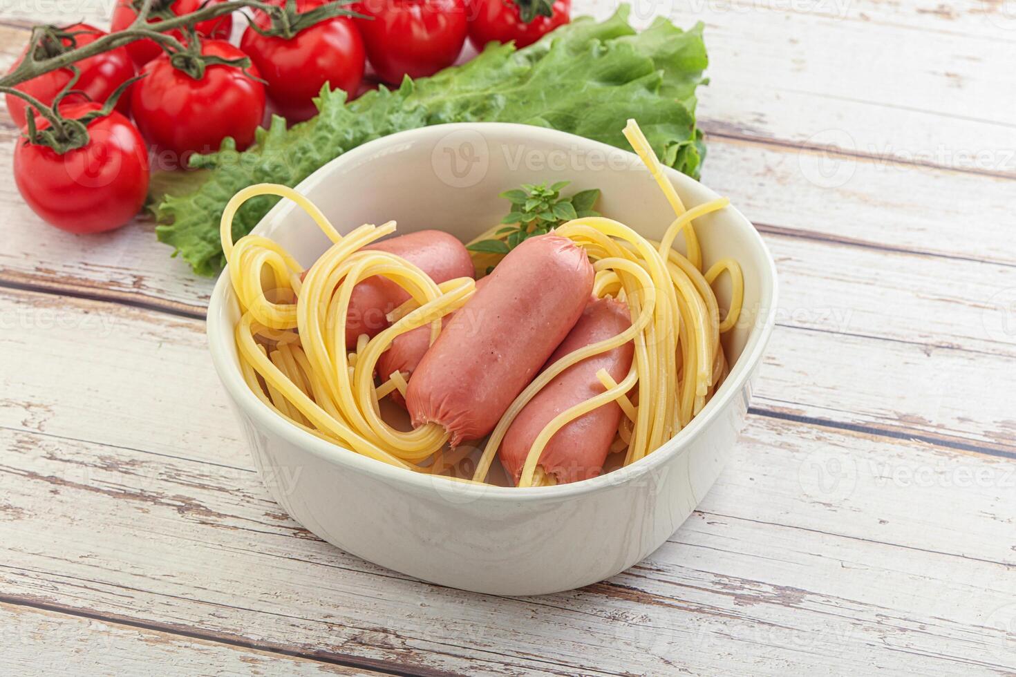 Mini sausages with pasta spaghetti photo