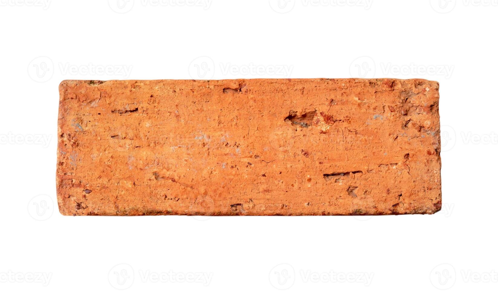 Single old cracked red or orange brick isolated on white background with clipping path photo