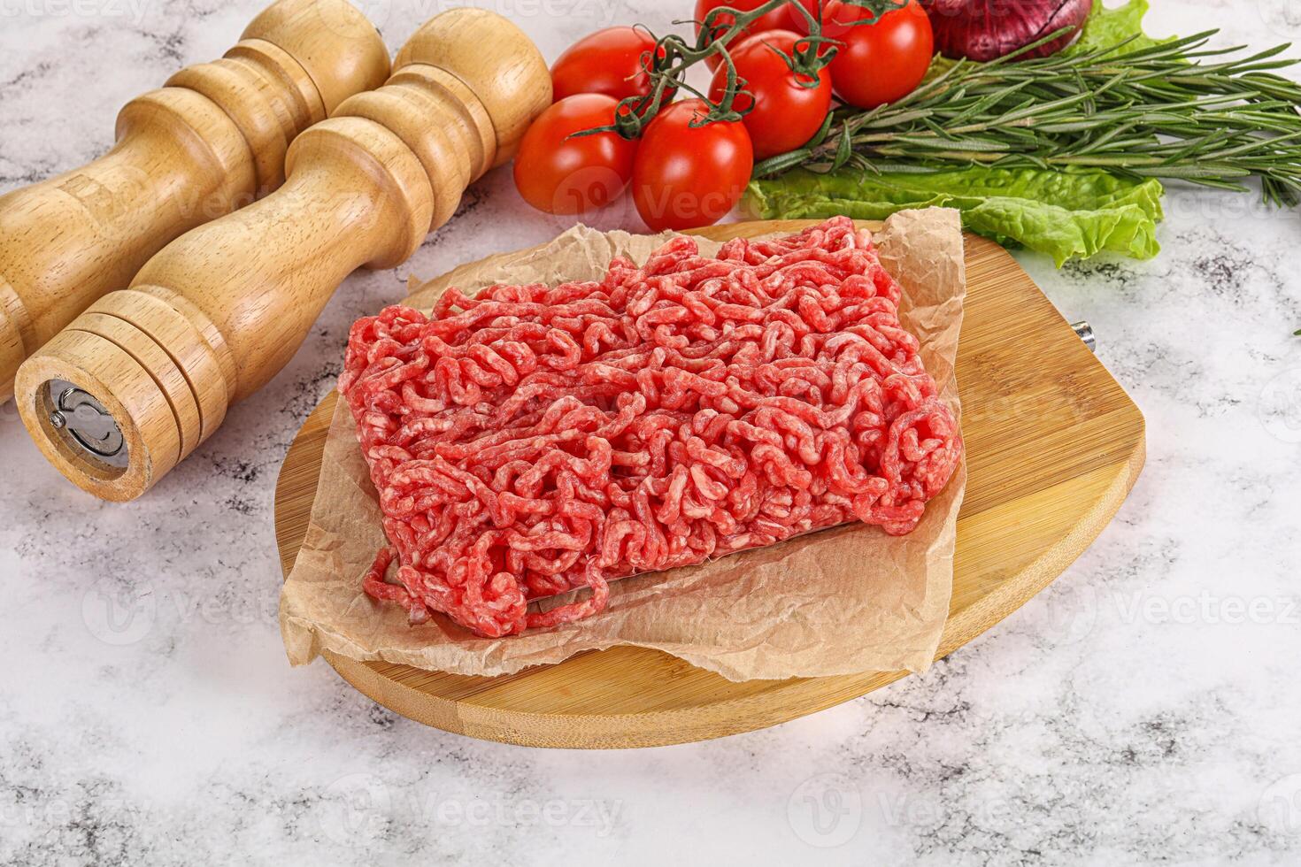 Raw minced beef meat on cutting board photo