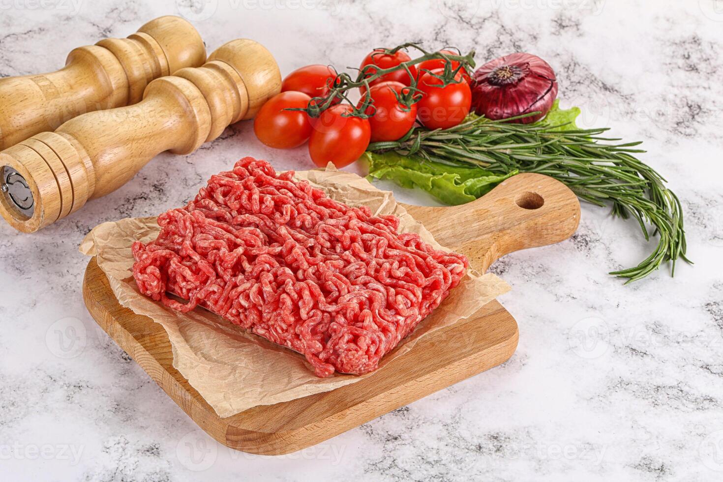 Raw minced beef meat on cutting board photo