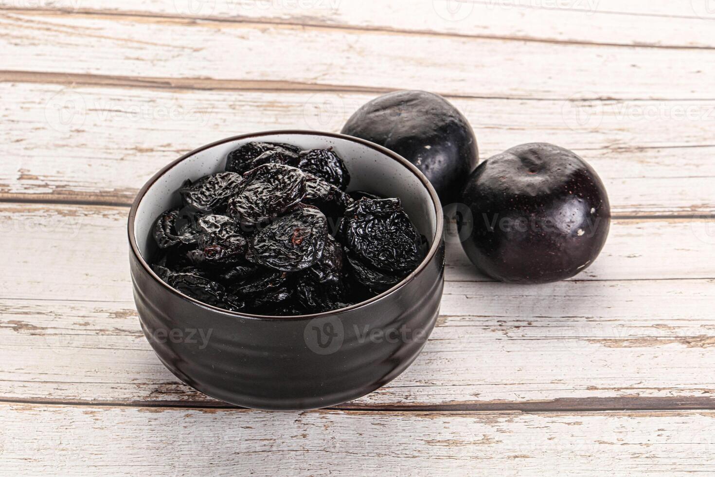 Dry prunes in thw bowl photo