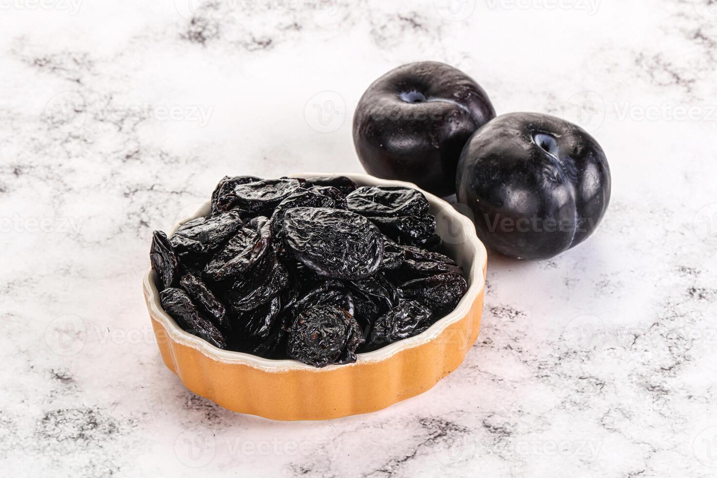 Dry prunes in thw bowl photo