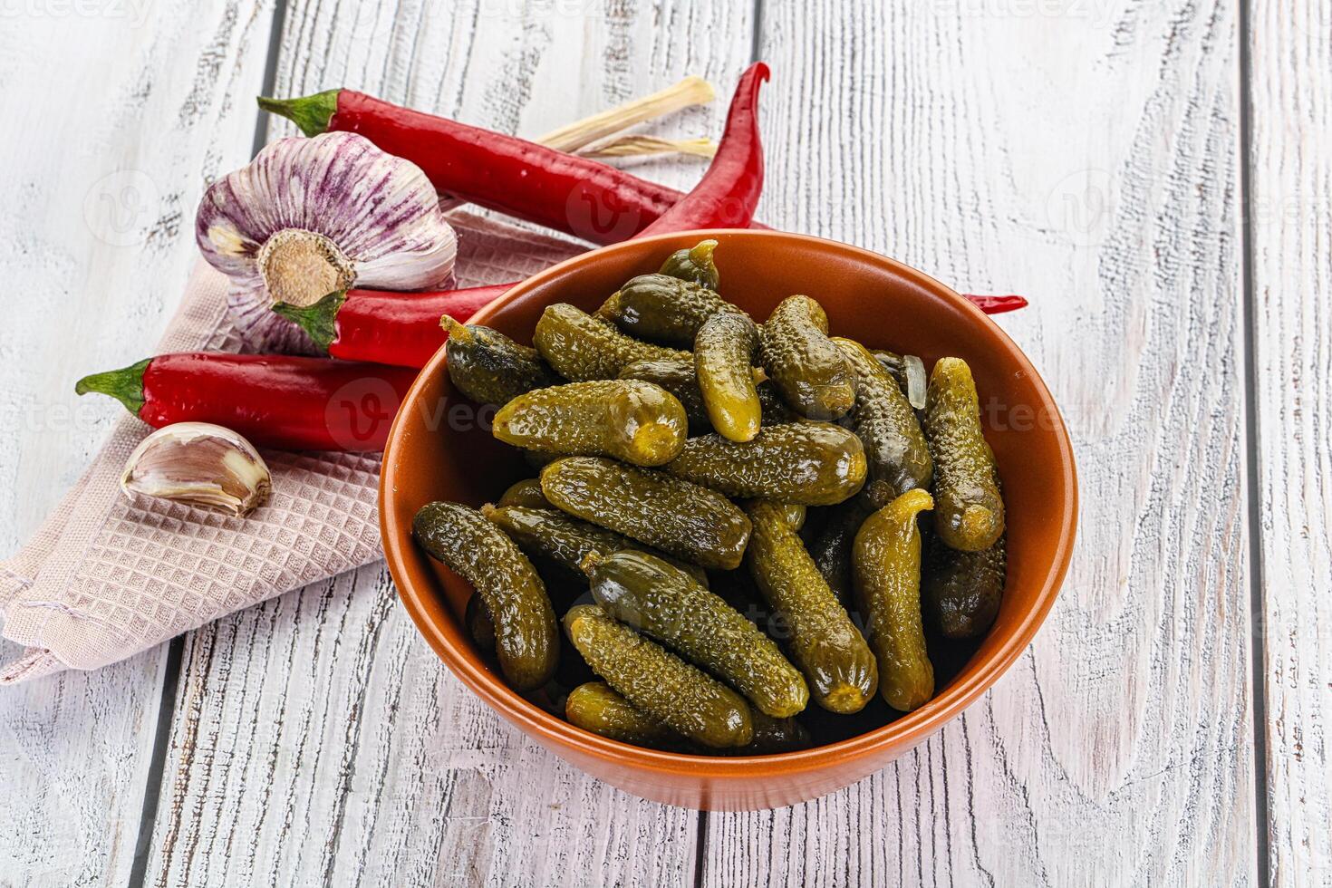 Marinated small cucumbers in the bowl photo