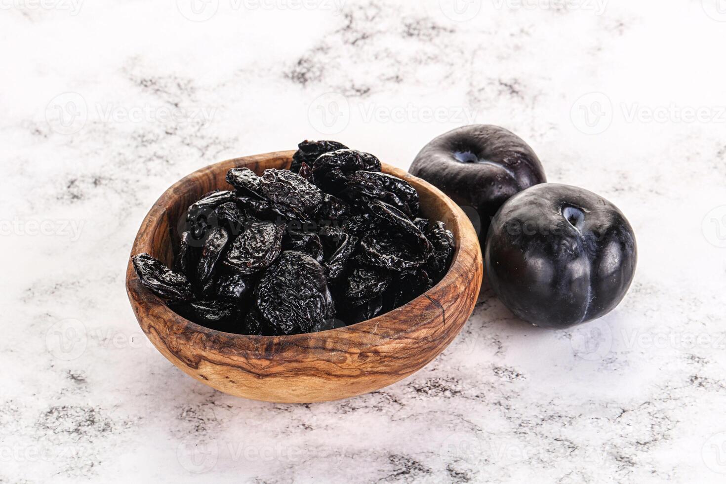 Dry prunes in thw bowl photo