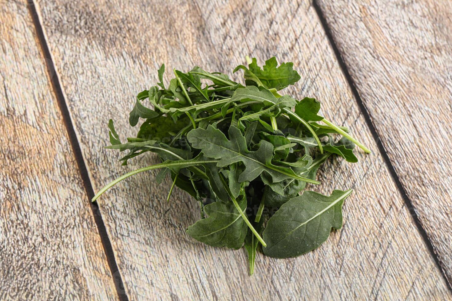 Green Arugula heap over background photo