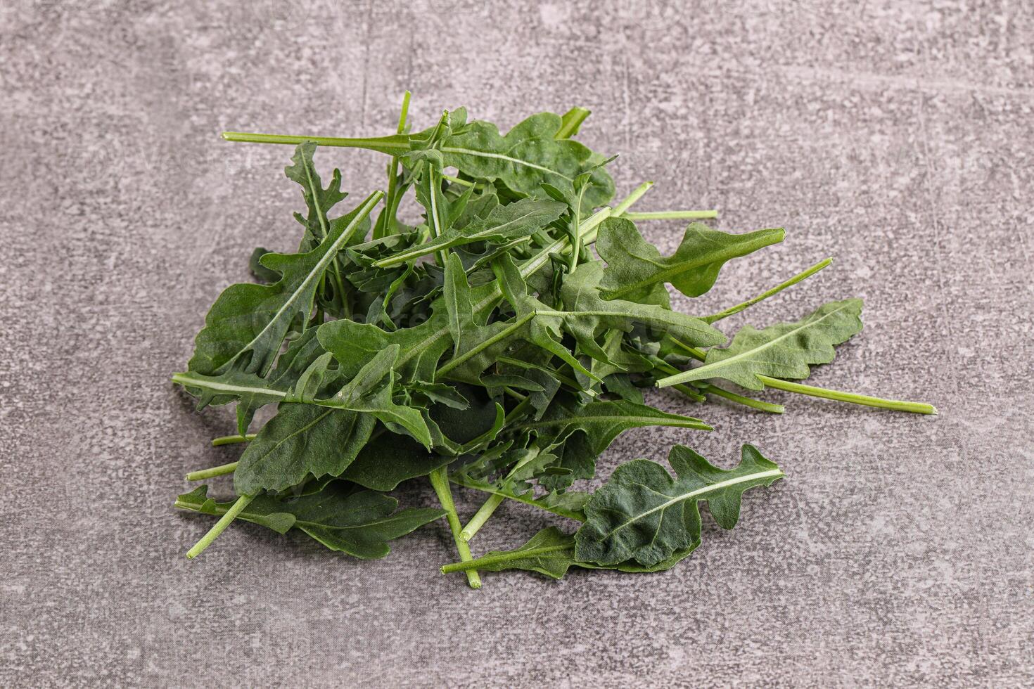 Green Arugula heap over background photo