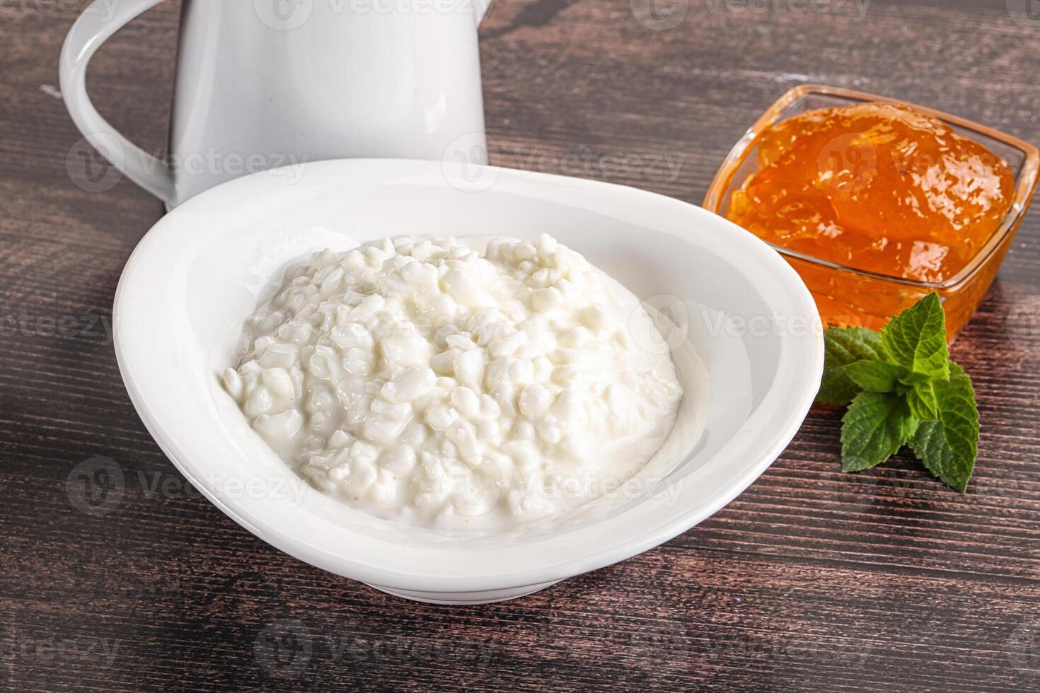Grain curd with cream and jam photo