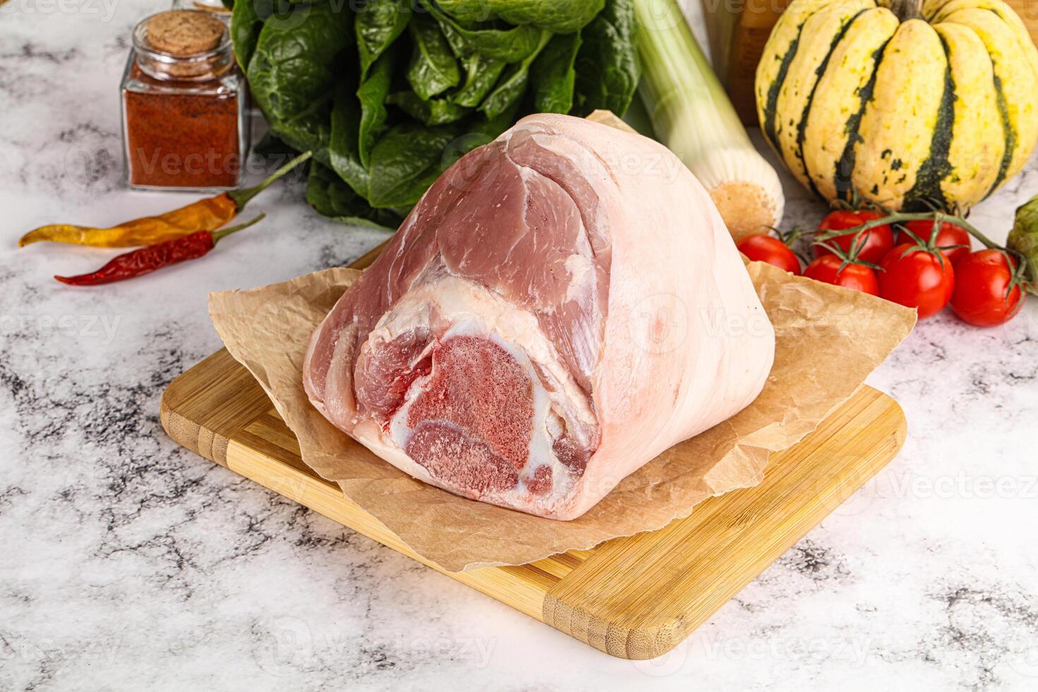 Uncooked raw pork knuckle with spices photo