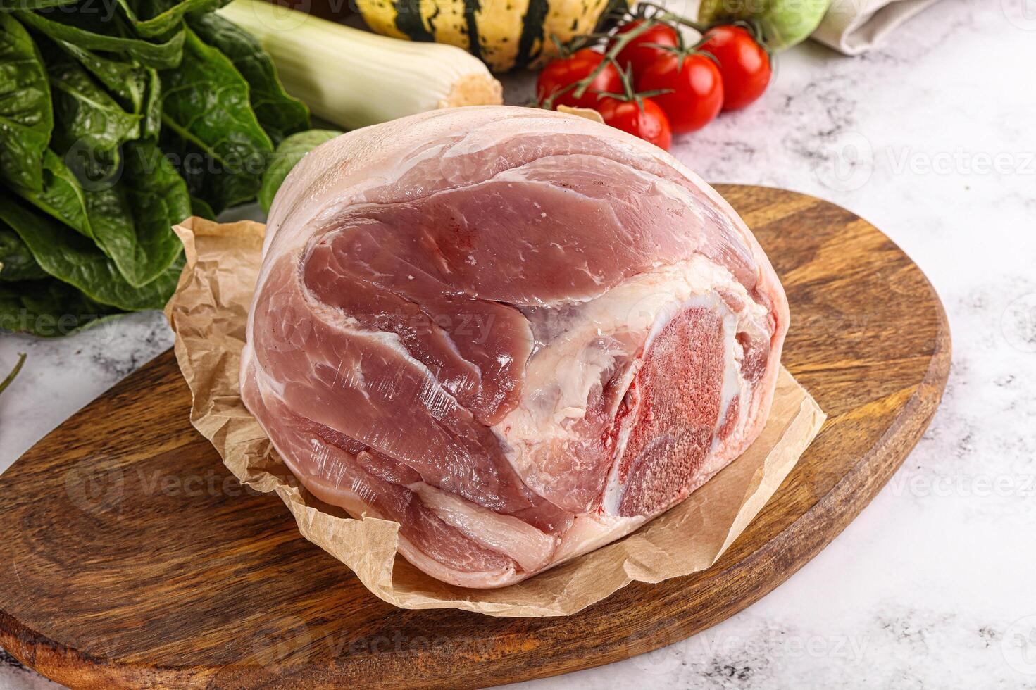 Uncooked raw pork knuckle with spices photo