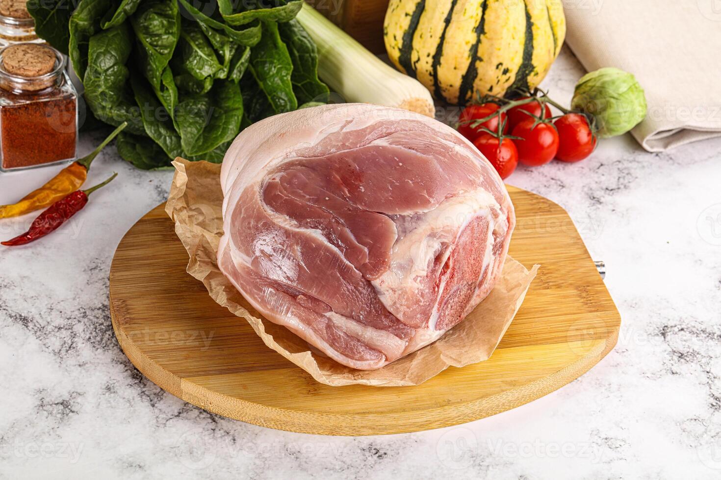 Uncooked raw pork knuckle with spices photo