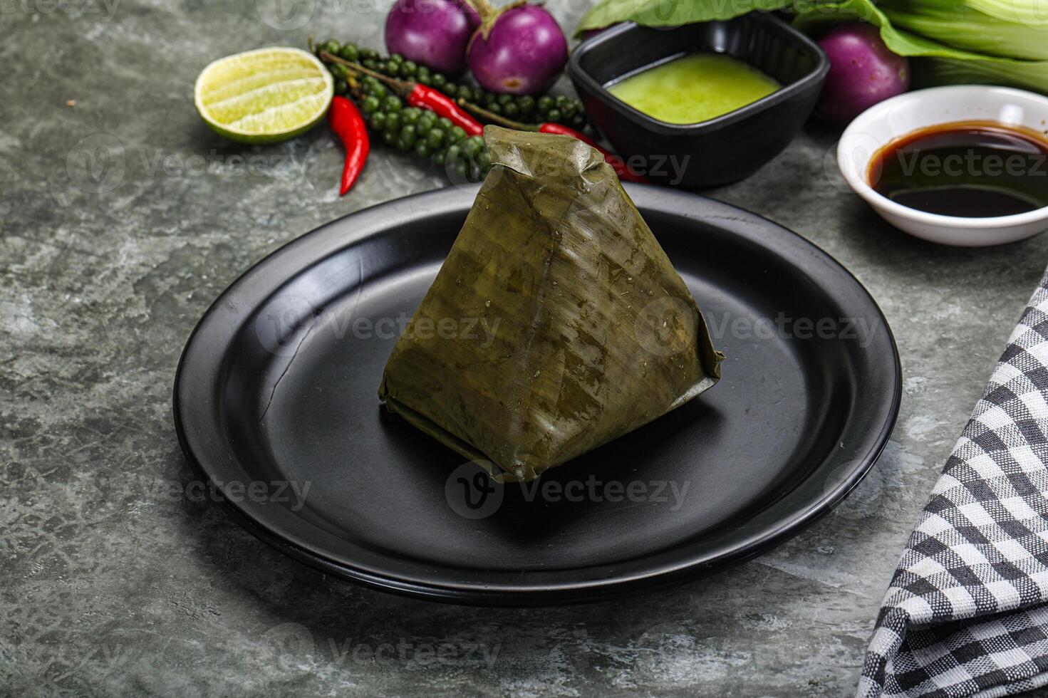 Asian cuisine - rice with filling in banana leaf photo