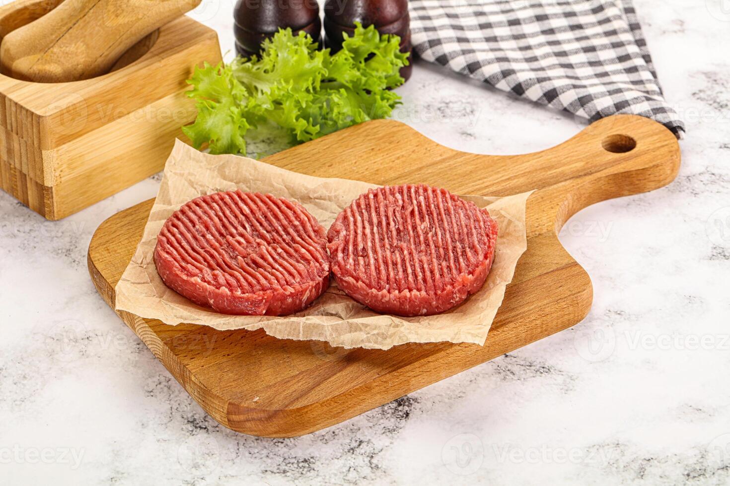 Raw beef  burger cutlet for grill photo