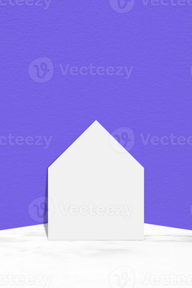 White Paper Cutting House on Marble Table with Light Blue Concrete Wall Background, Suitable for Product Presentation Backdrop, Display, and Mock up for Social Media or Mobile Phone. photo