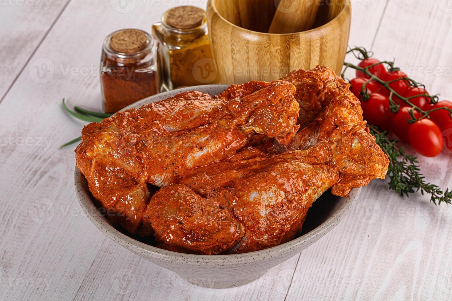 Raw turkey shoulder wing in Indian tandoori marinade photo