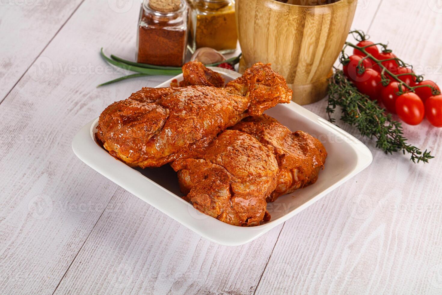 Raw turkey shoulder wing in Indian tandoori marinade photo