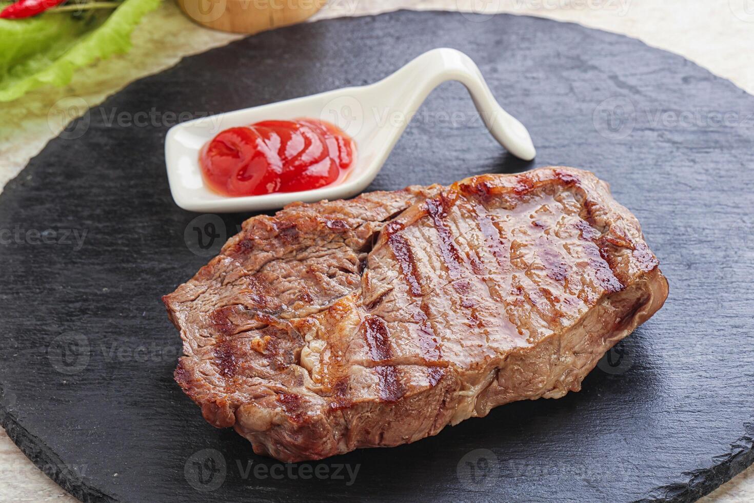 Grilled rib-eye steak beef meat photo