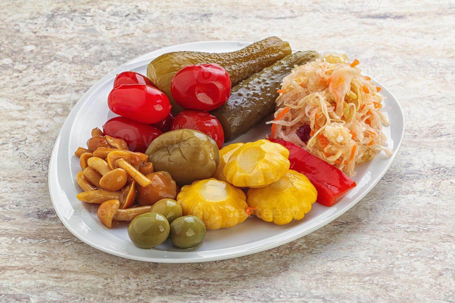 Plate with pickled vegetables and mushrooms photo