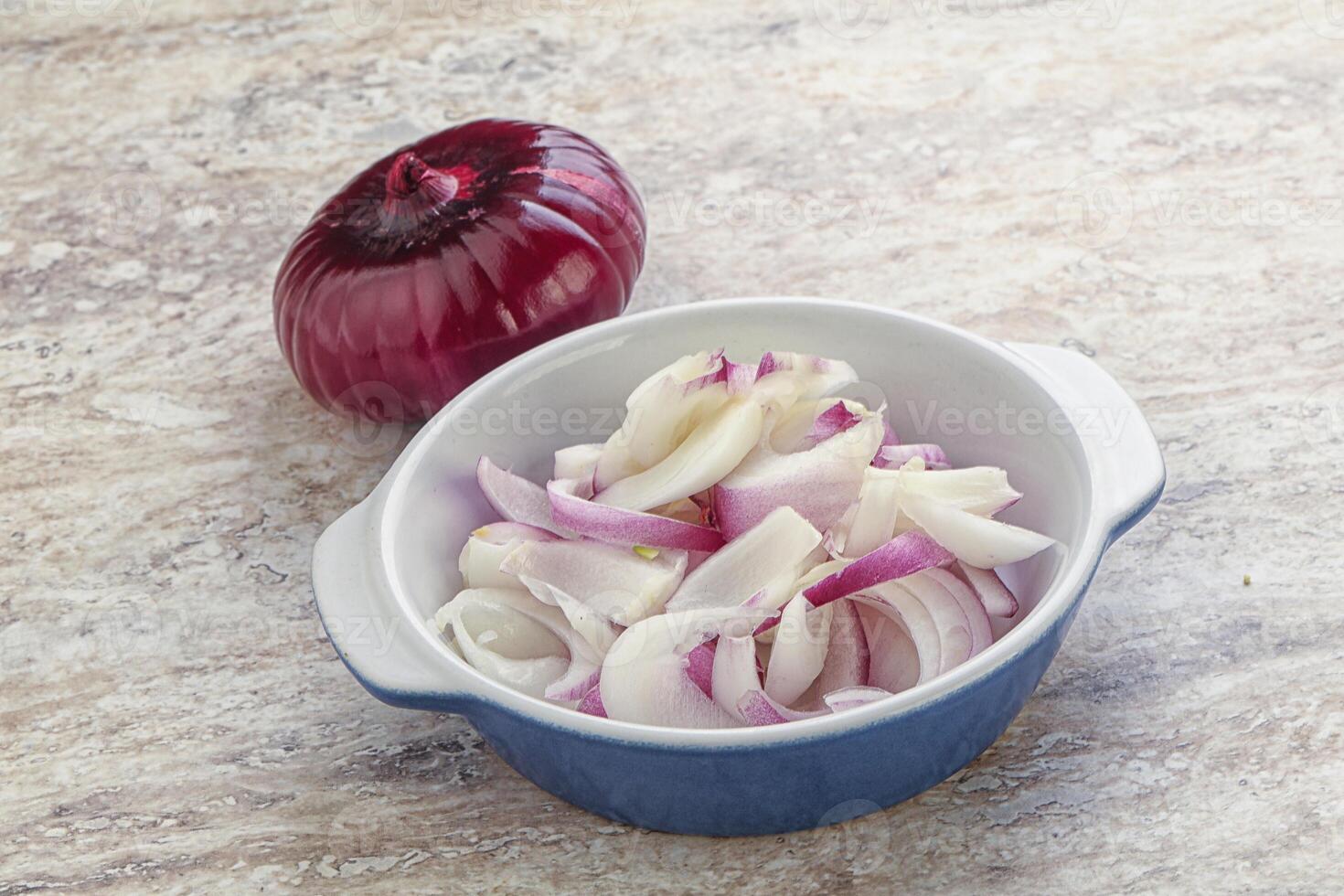 Sliced red onion in the bowl photo