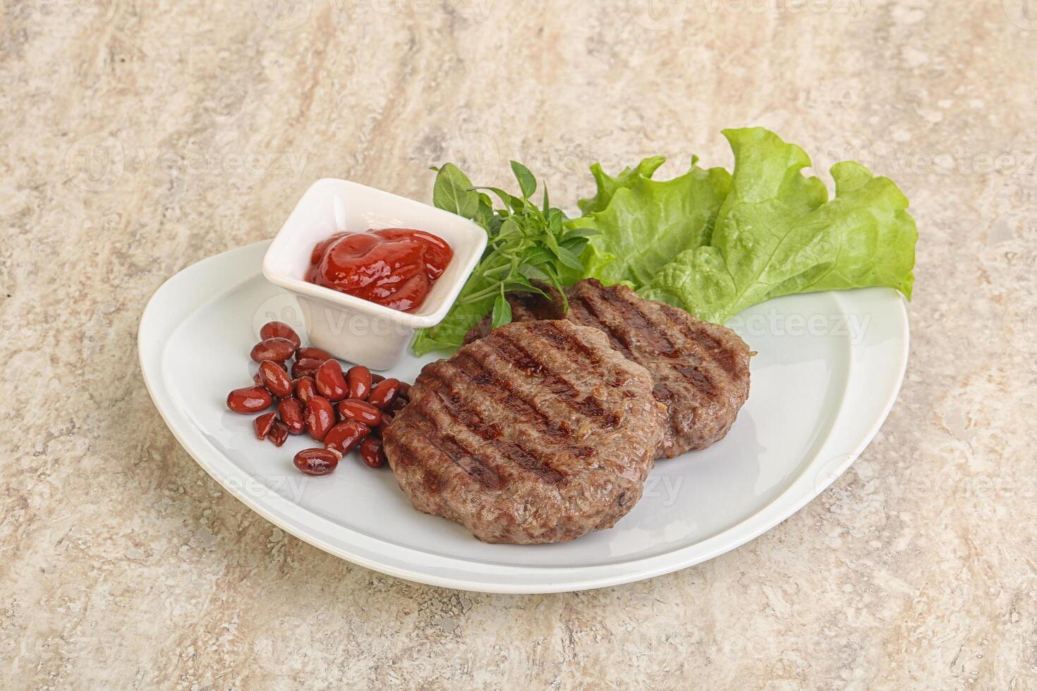 Grilled beef burger cutlet with sauce photo