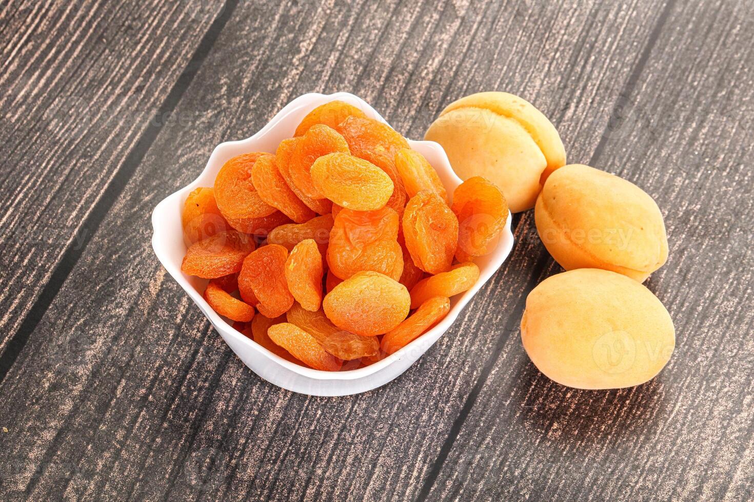 Dried apricot heap in the bowl photo