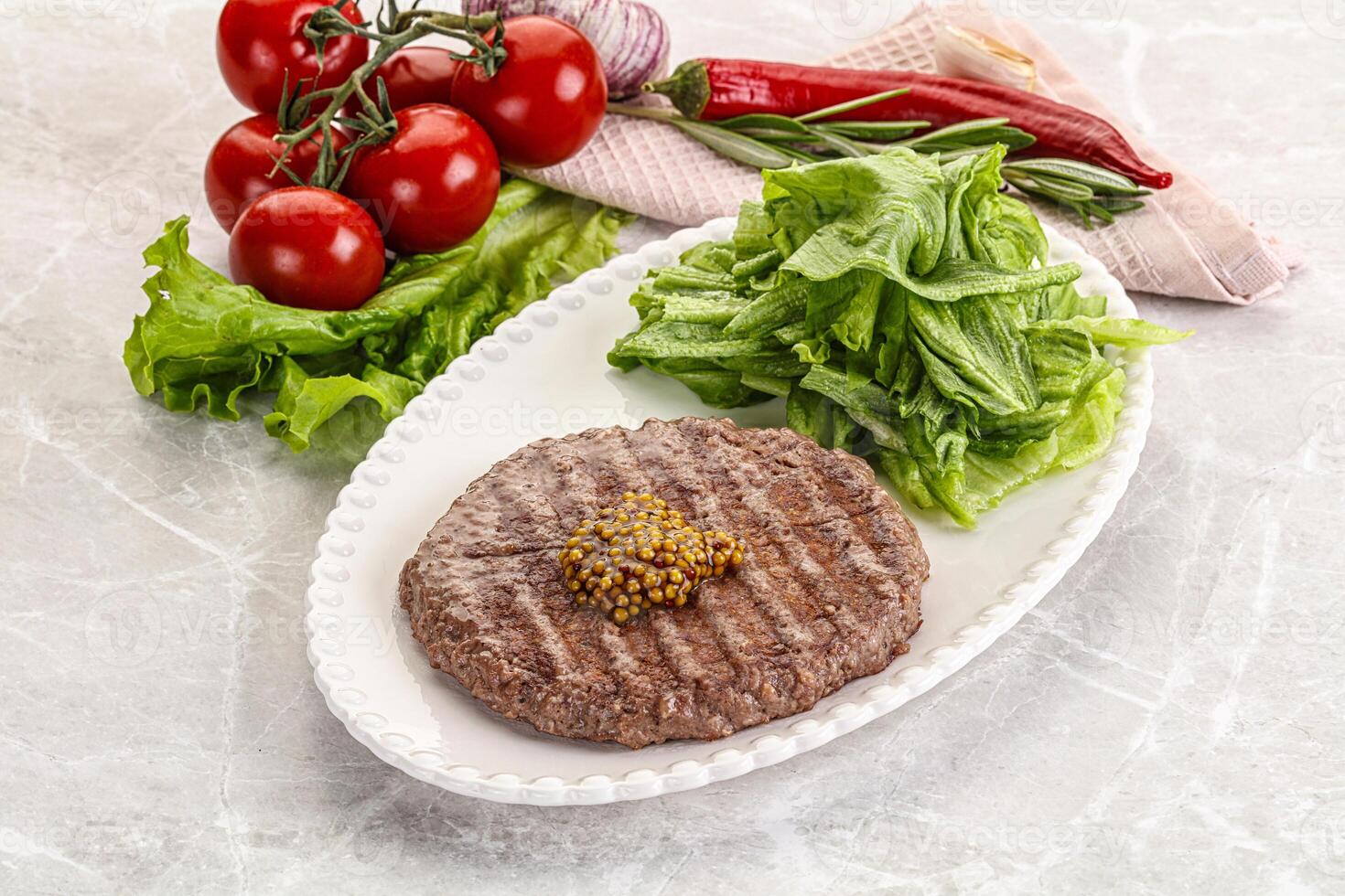 Frilled beef burger cutlet with iceberg photo