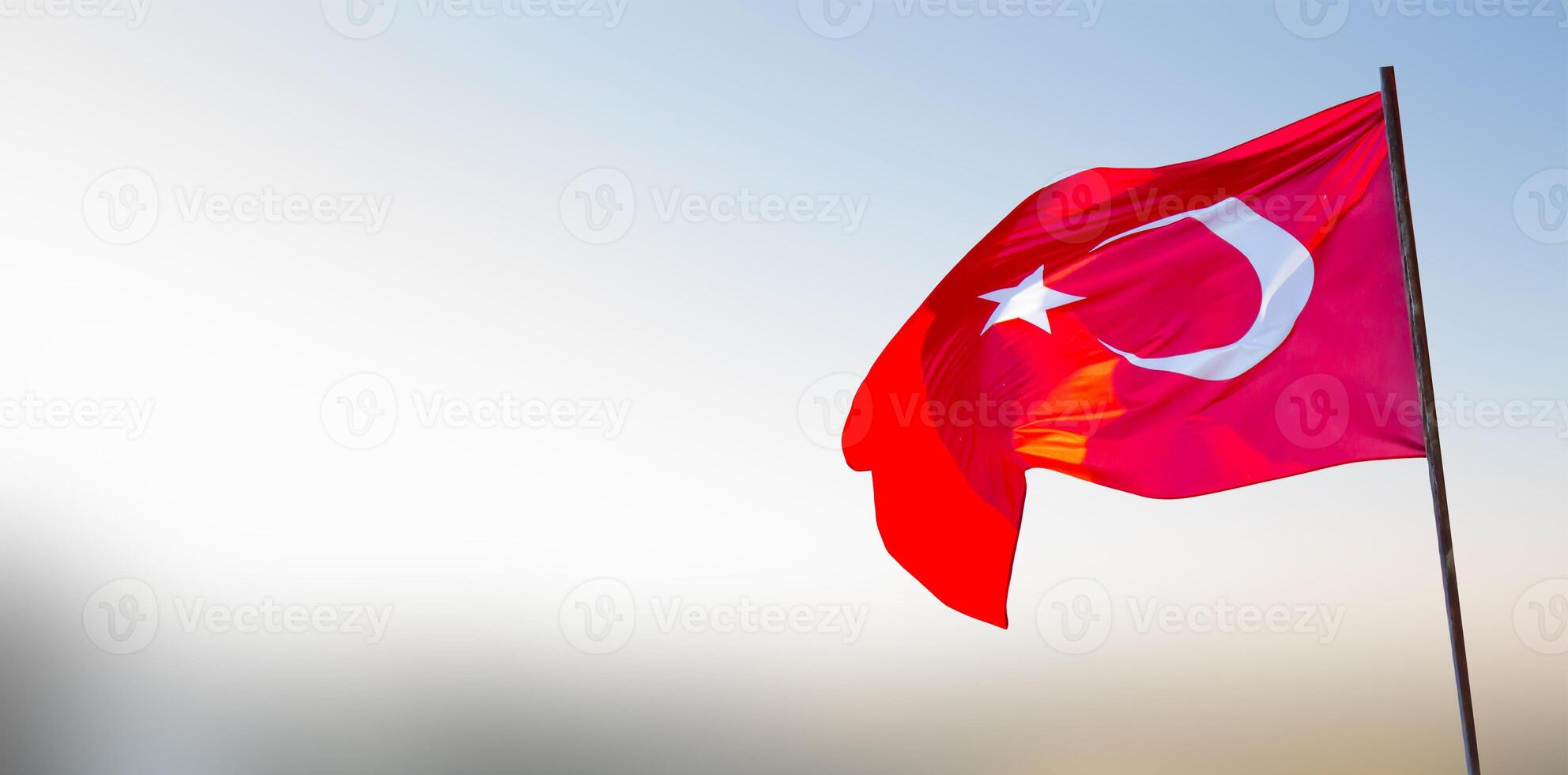 Turkish flag waving on sky with copy space photo